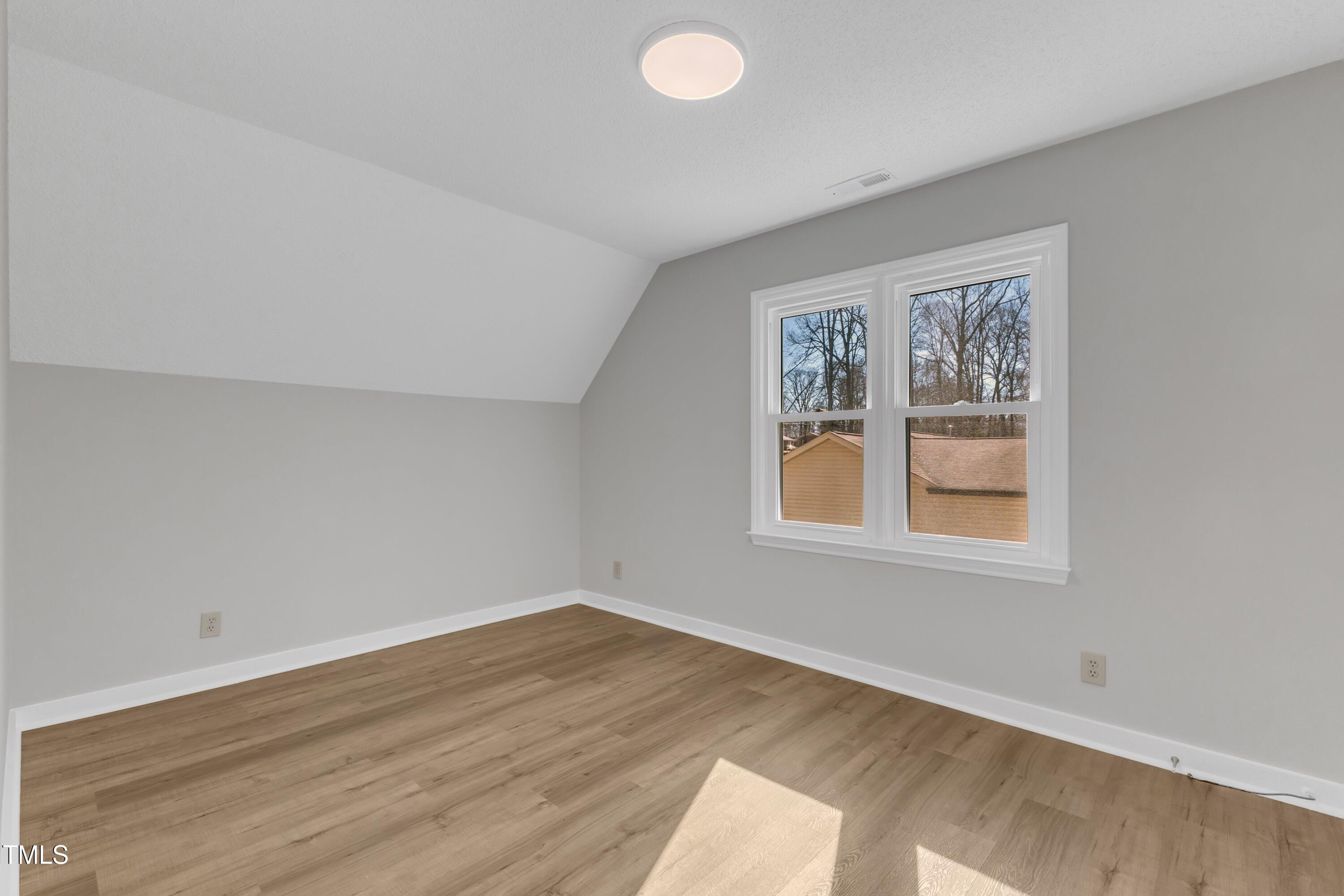 612 Miller Road Hillsborough, NC 27278 - Photo 21 of 35 an empty room with wooden floor and windows