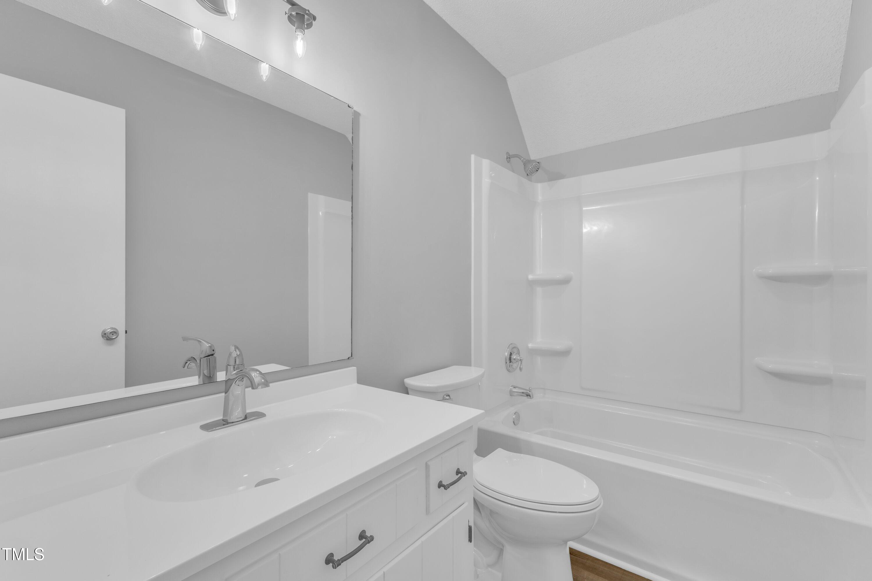 612 Miller Road Hillsborough, NC 27278 - Photo 22 of 35 a bathroom with a sink a toilet and a large mirror