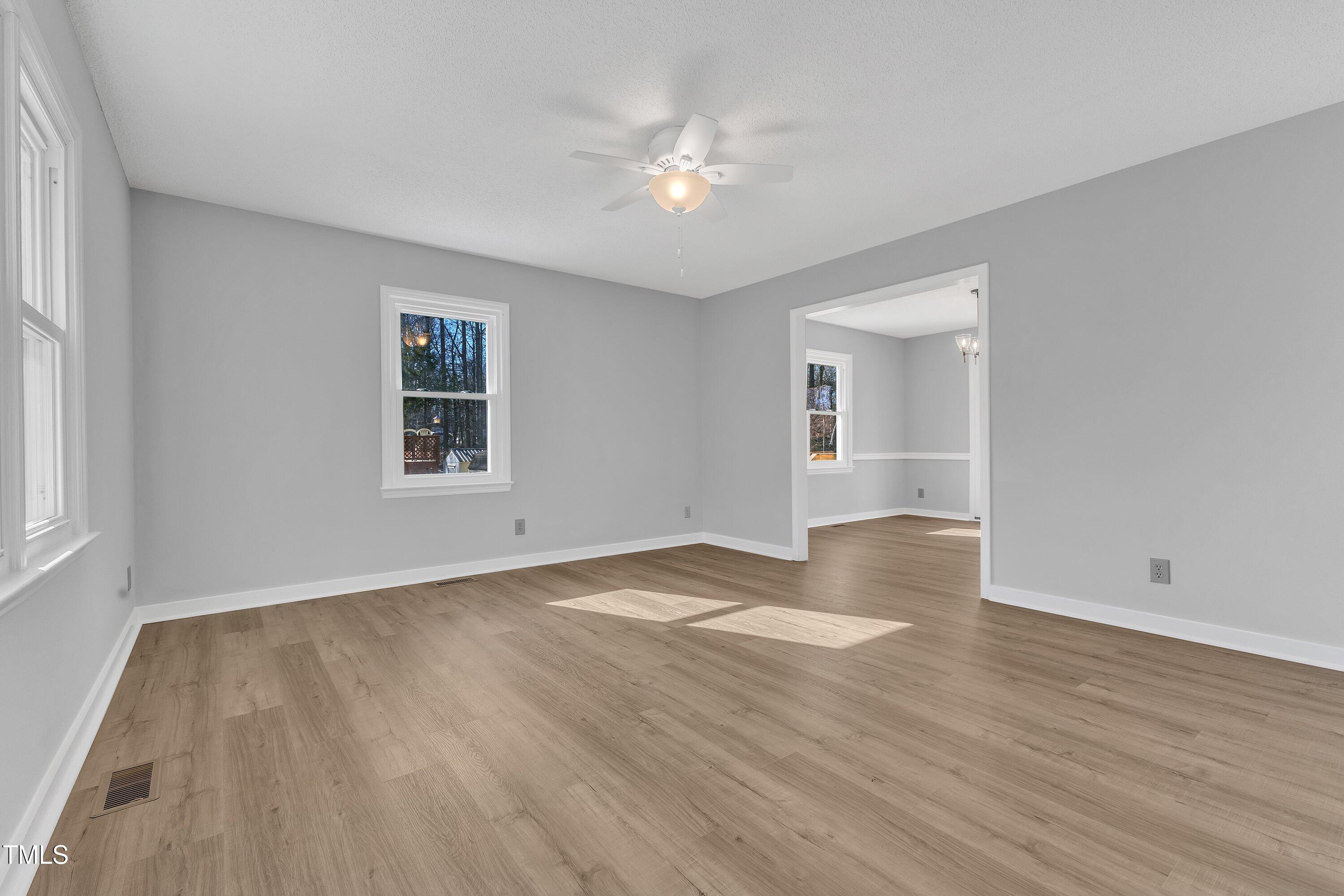 612 Miller Road Hillsborough, NC 27278 - Photo 4 of 35 a view of an empty room with wooden floor and a window