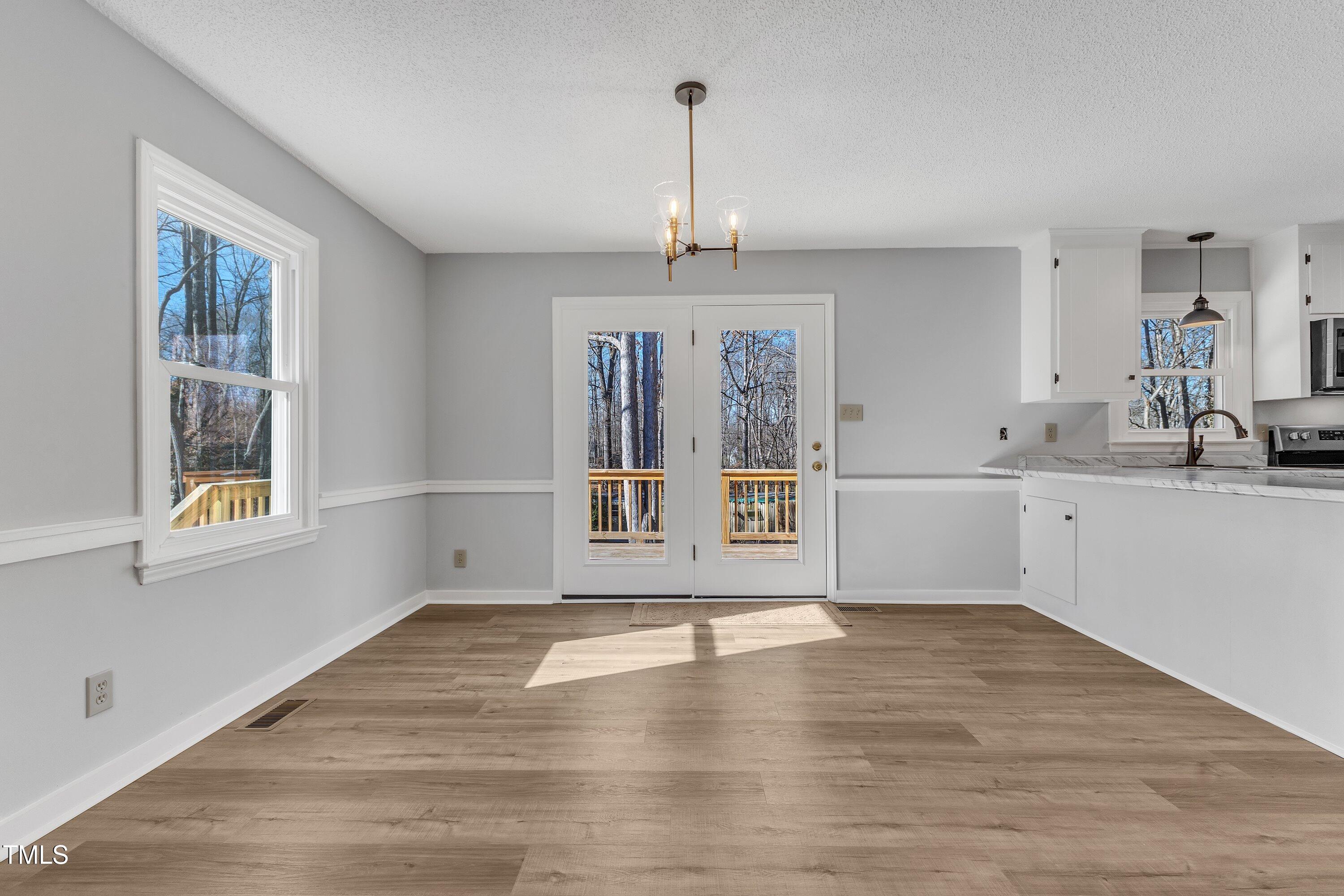 612 Miller Road Hillsborough, NC 27278 - Photo 7 of 35 a view of an empty room with a window and wooden floor