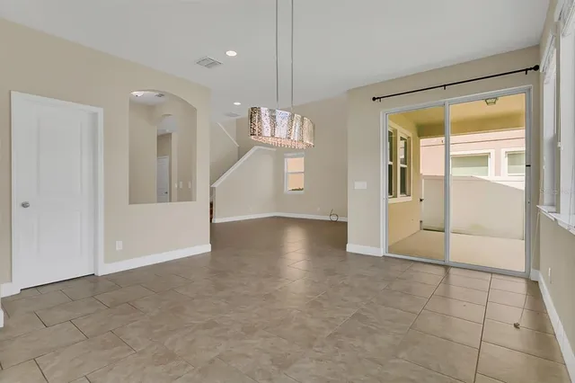 a view of an empty room with window and cabinet