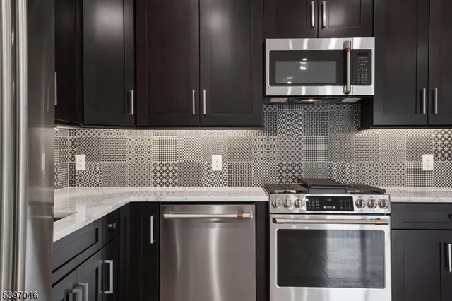 a view of kitchen with wooden floor electronic appliances and window
