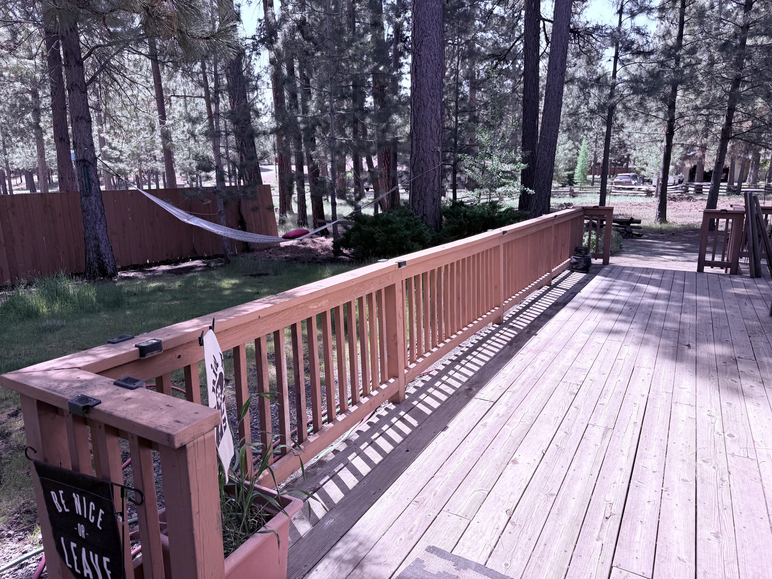68964 Graham Court Sisters, OR 97759 - Photo 5 of 28 a view of deck with two chairs and wooden fence