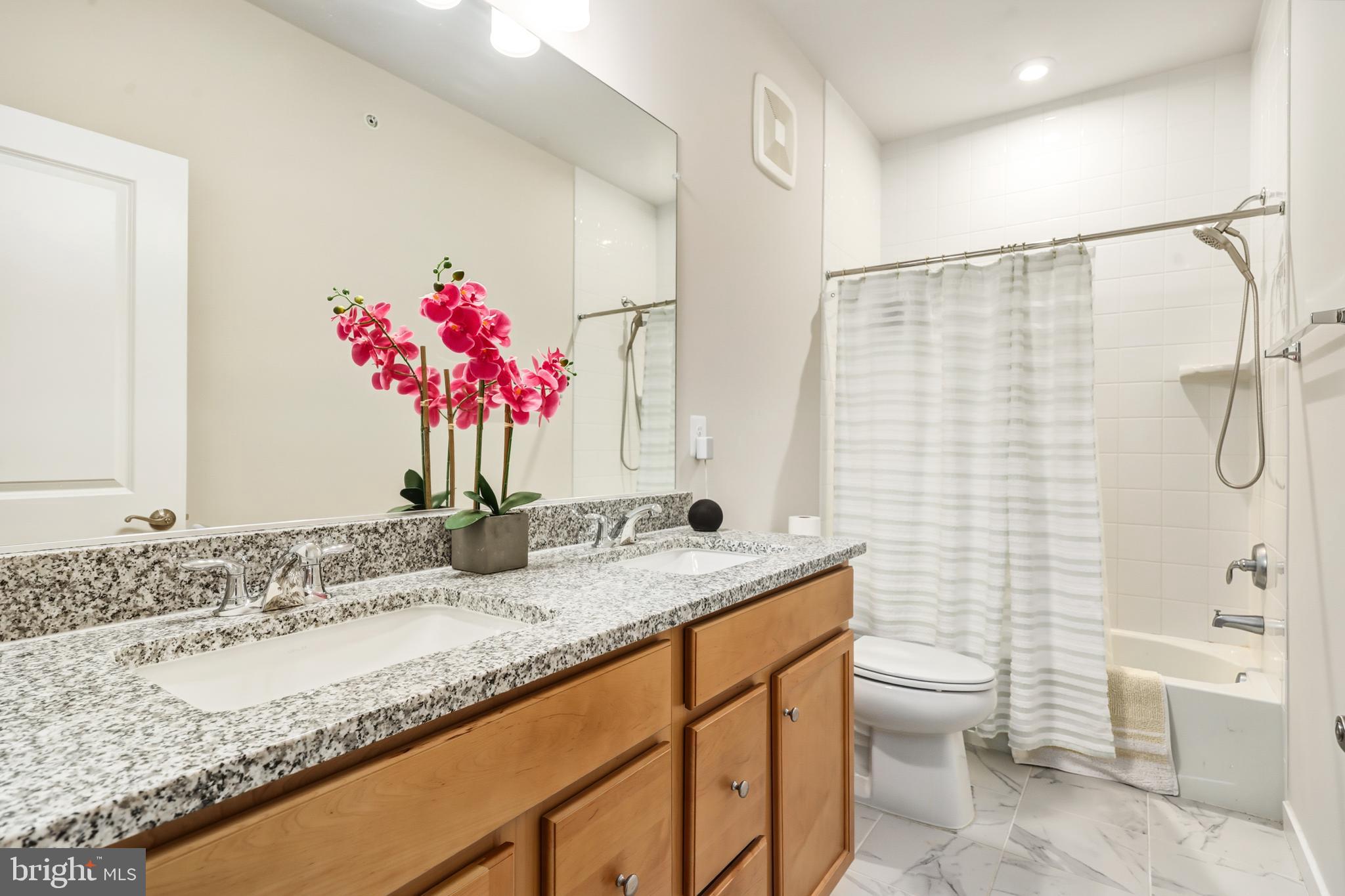 13508 INNOVATION Sta Loop Herndon, VA 20171 - Photo 24 of 29 a bathroom with a granite countertop sink a toilet and shower