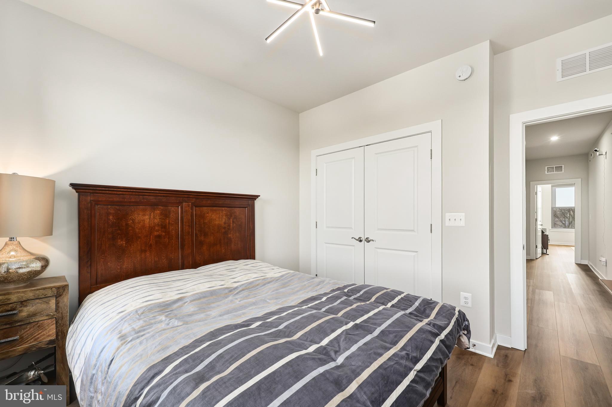 13508 INNOVATION Sta Loop Herndon, VA 20171 - Photo 26 of 29 a bedroom with a bed and a chandelier