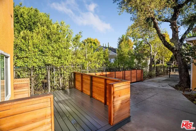 a view of backyard with deck and trees