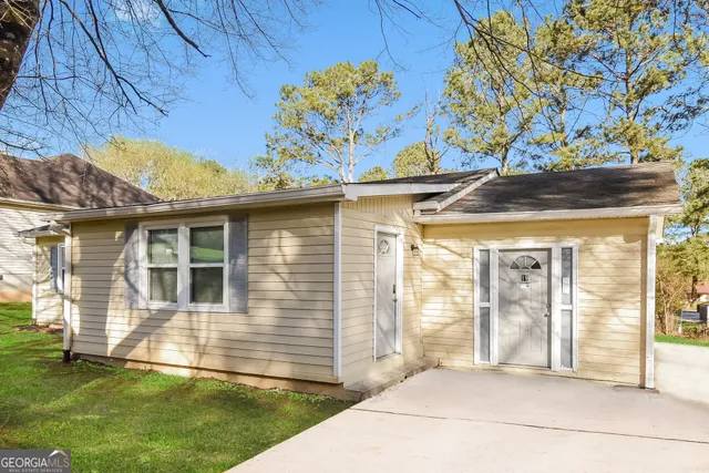 a front view of a house with a big yard