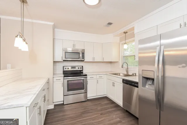 a kitchen with a sink stove and refrigerator