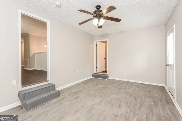 wooden floor in an empty room with a window