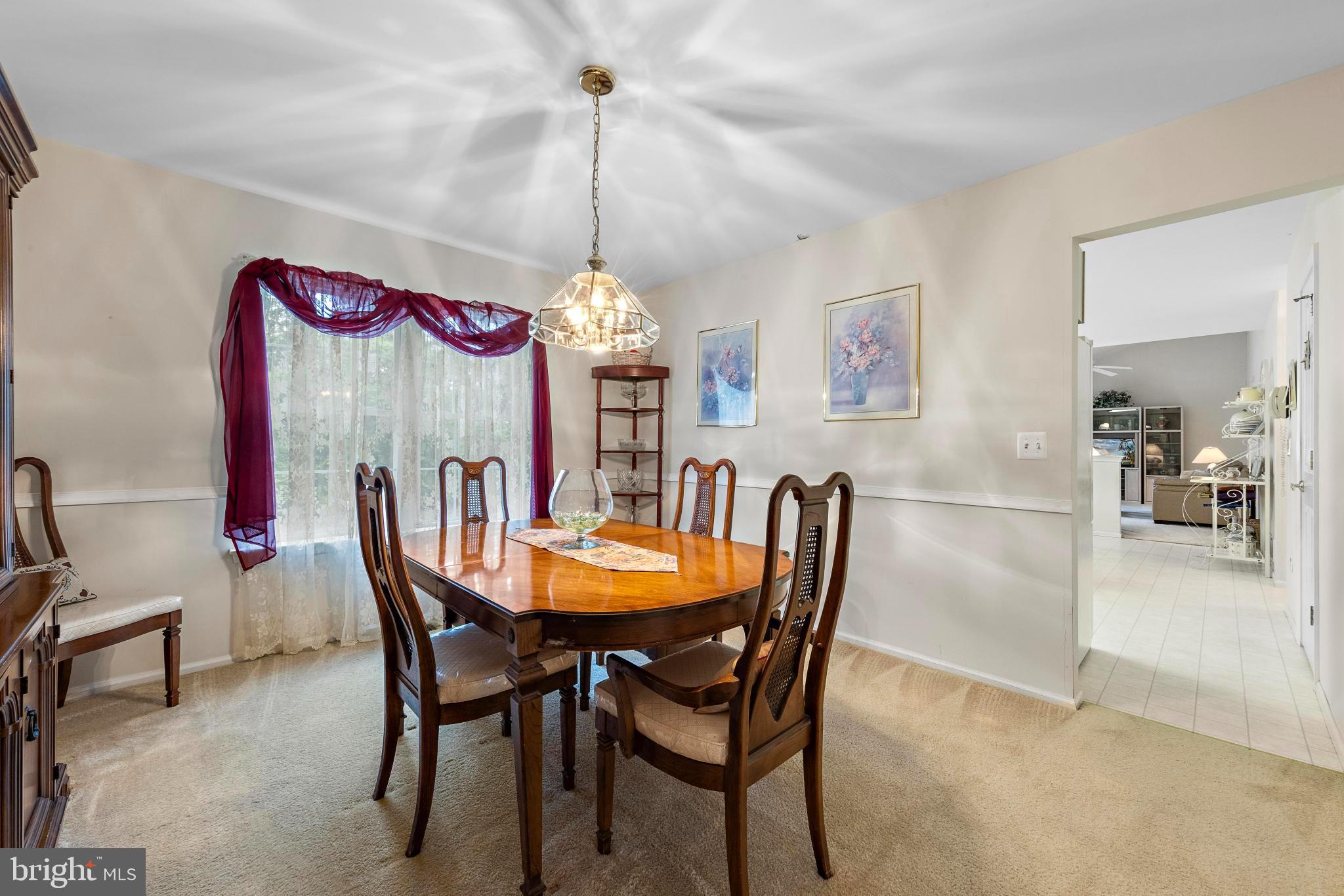 249 Topside Road Manahawkin, NJ 08050 - Photo 12 of 49 a view of a dining room with furniture and chandelier