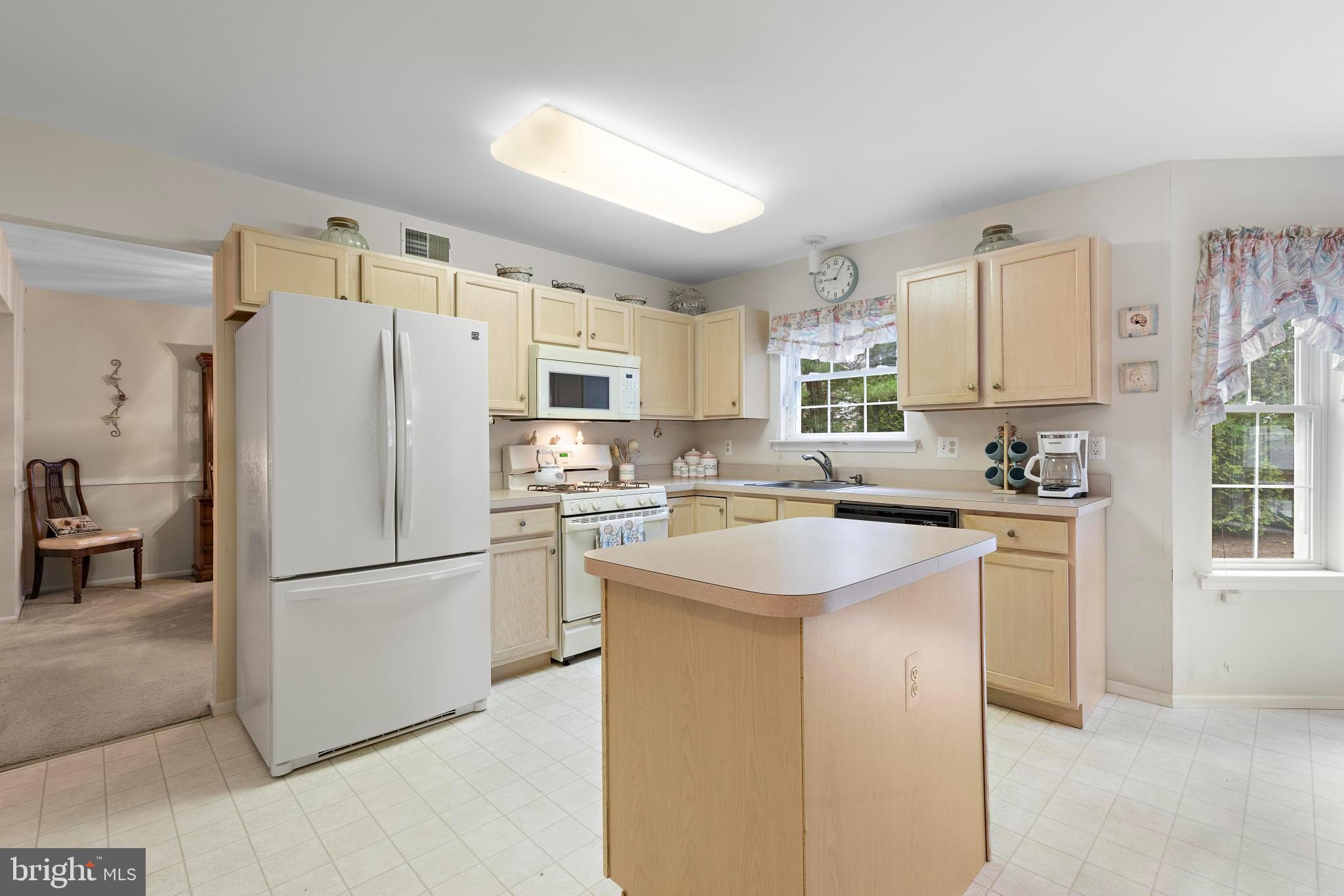 249 Topside Road Manahawkin, NJ 08050 - Photo 13 of 49 a kitchen with stainless steel appliances granite countertop a refrigerator a sink dishwasher a stove a refrigerator and white cabinets with wooden floor