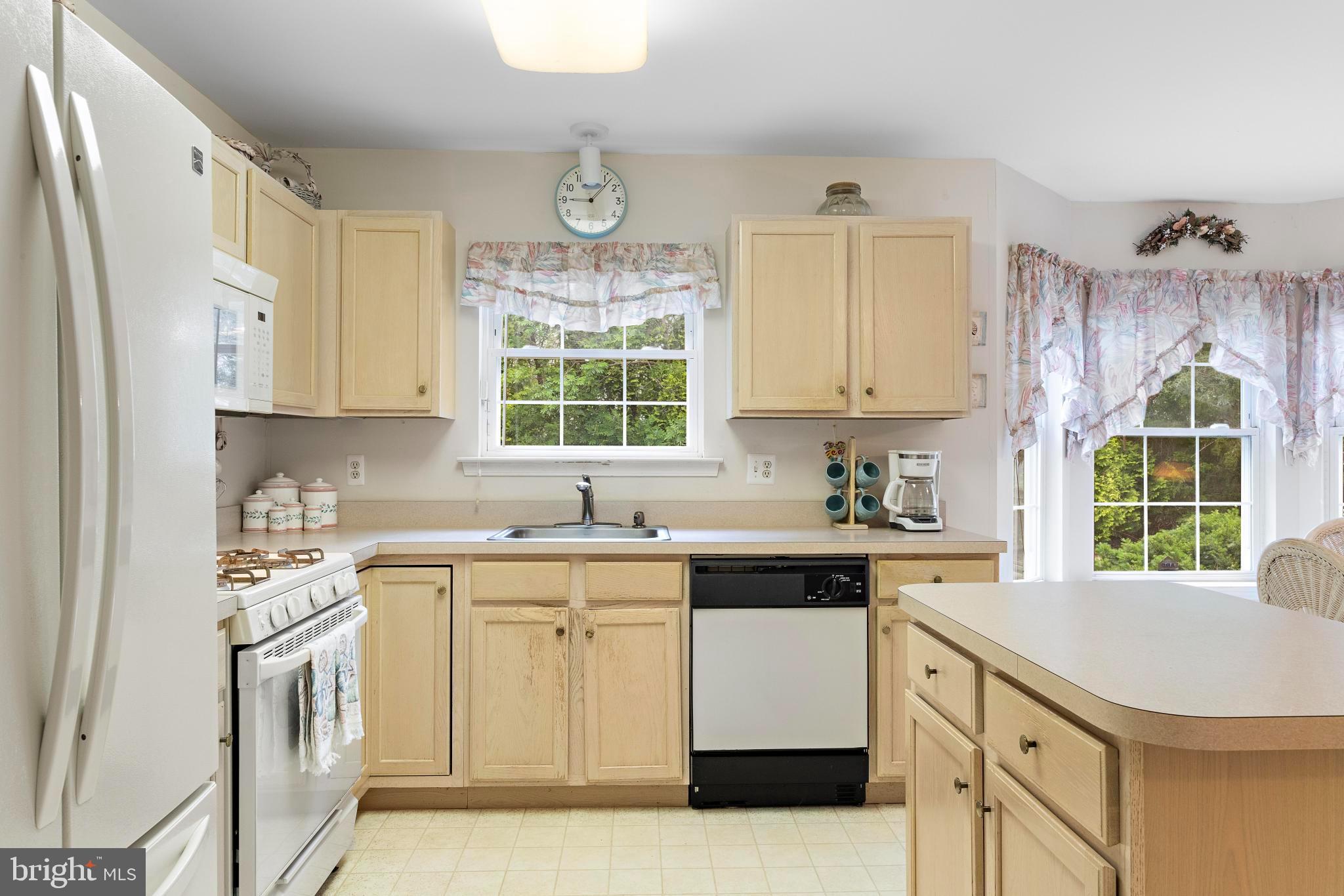 249 Topside Road Manahawkin, NJ 08050 - Photo 14 of 49 a kitchen with a sink stove and cabinets
