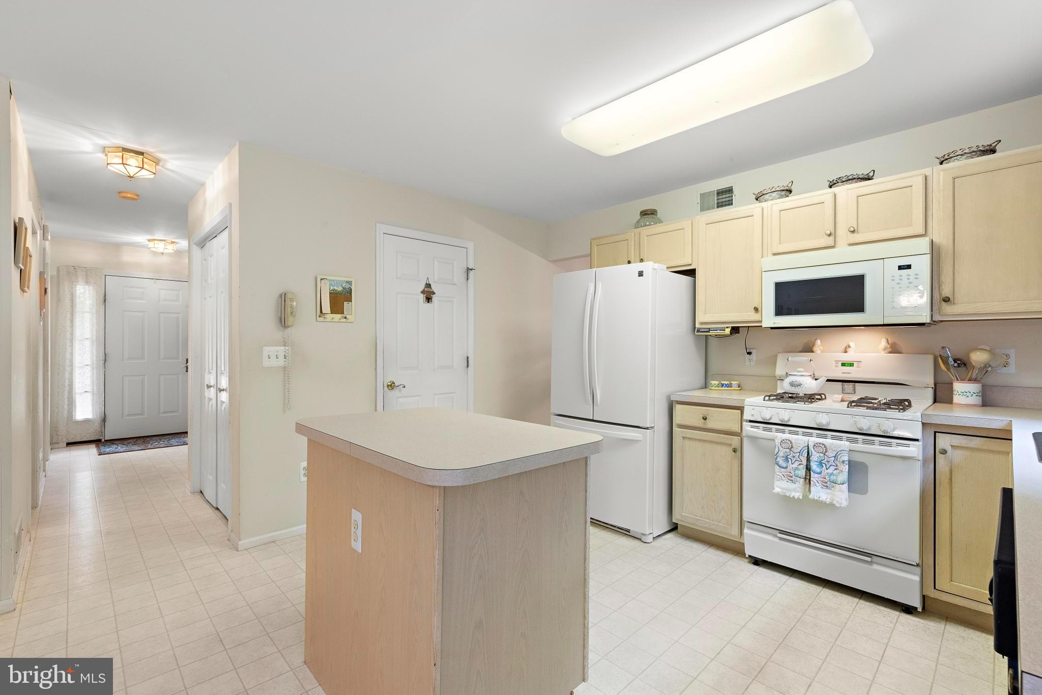 249 Topside Road Manahawkin, NJ 08050 - Photo 16 of 49 a kitchen with white cabinets and white appliances