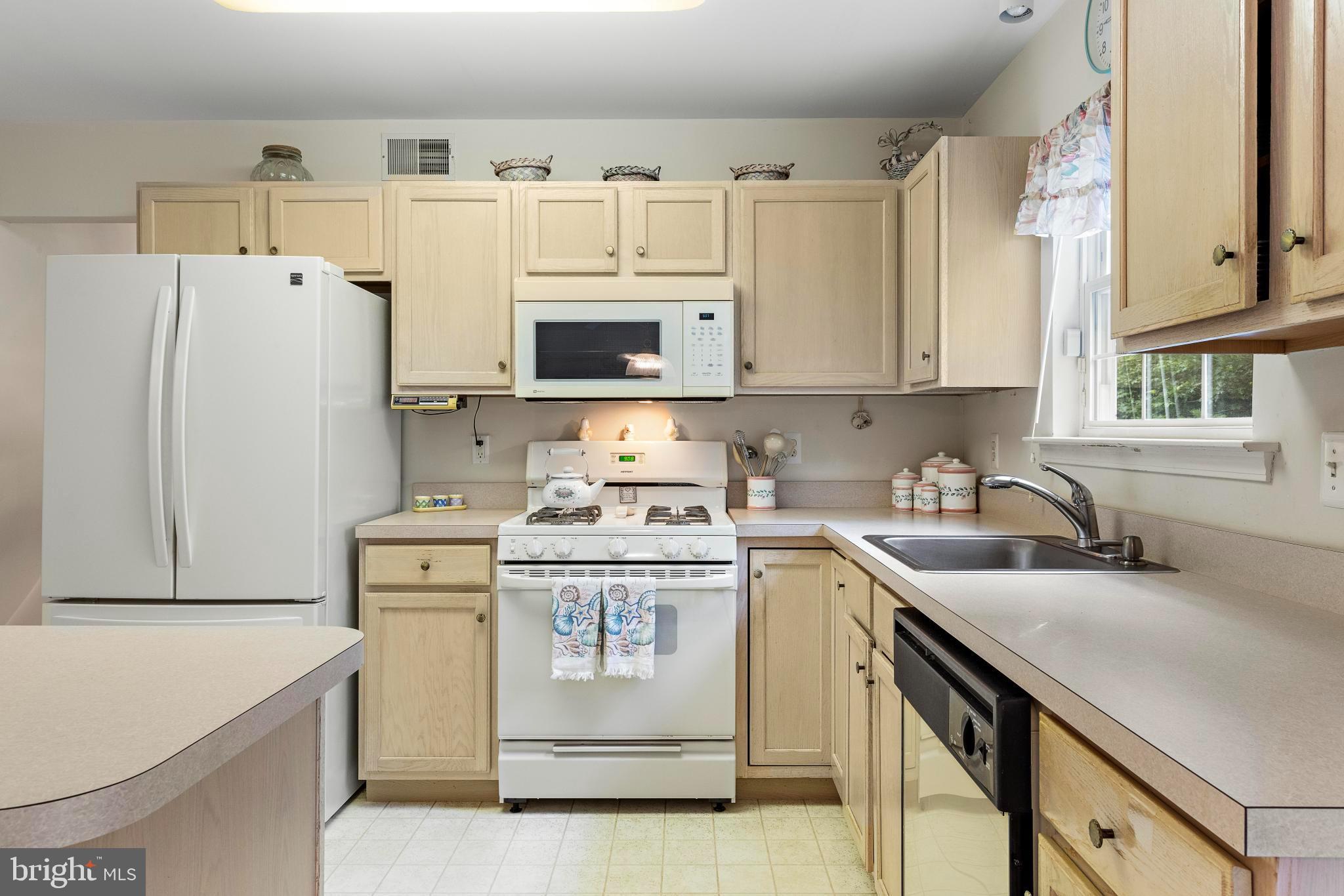 249 Topside Road Manahawkin, NJ 08050 - Photo 17 of 49 a kitchen with stainless steel appliances granite countertop a sink stove and refrigerator