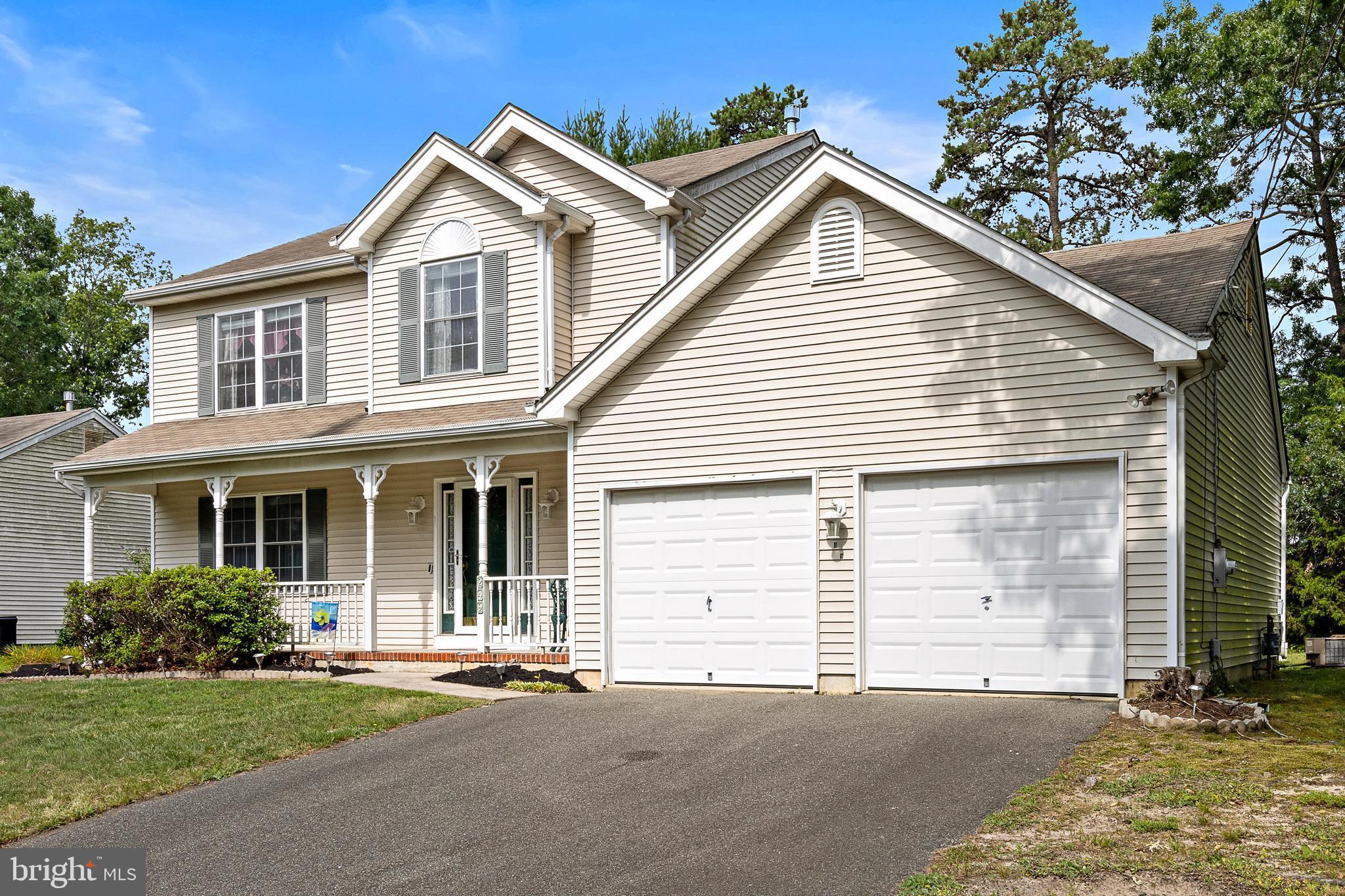 249 Topside Road Manahawkin, NJ 08050 - Photo 2 of 49 a view of a white house with a small yard and large parking space