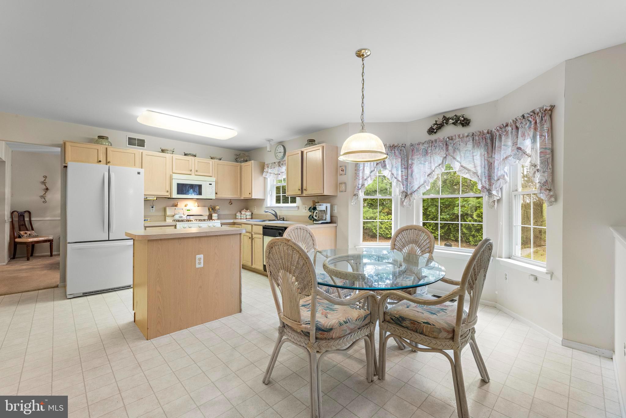 249 Topside Road Manahawkin, NJ 08050 - Photo 21 of 49 a view of a dining room and livingroom with furniture large windows a chandelier