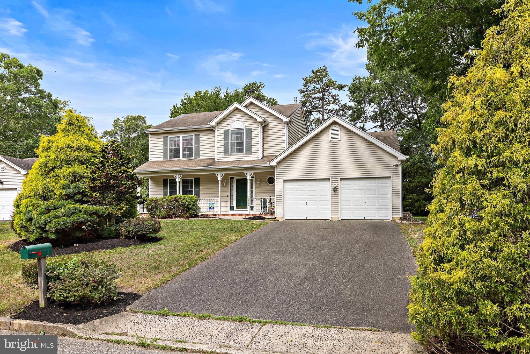 249 Topside Road Manahawkin, NJ 08050 - Photo 3 of 49 a front view of a house with a yard and potted plants