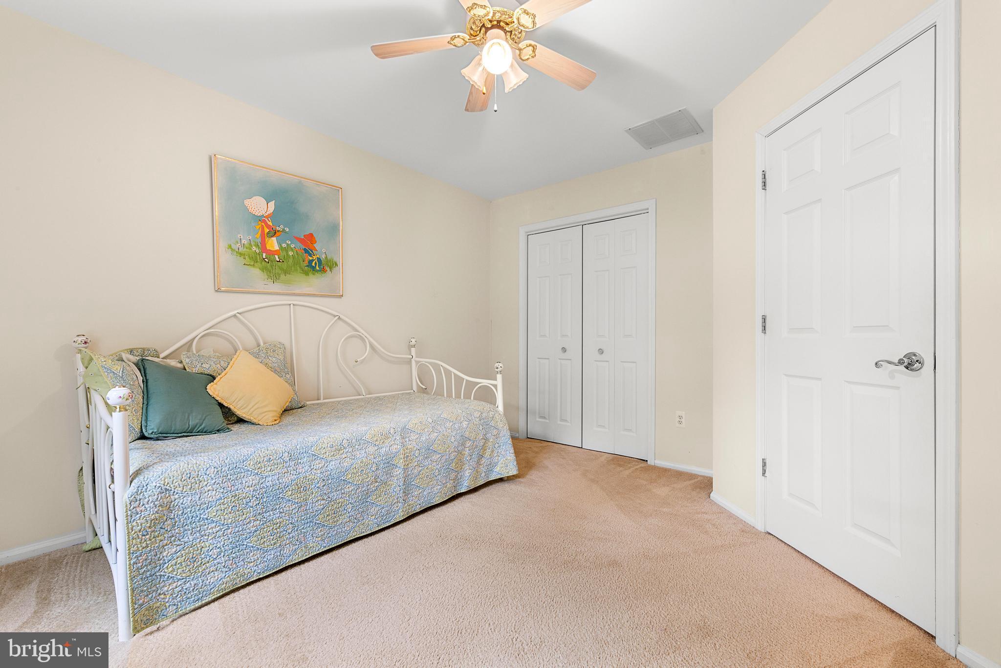 249 Topside Road Manahawkin, NJ 08050 - Photo 32 of 49 a bedroom with a bed and a chandelier