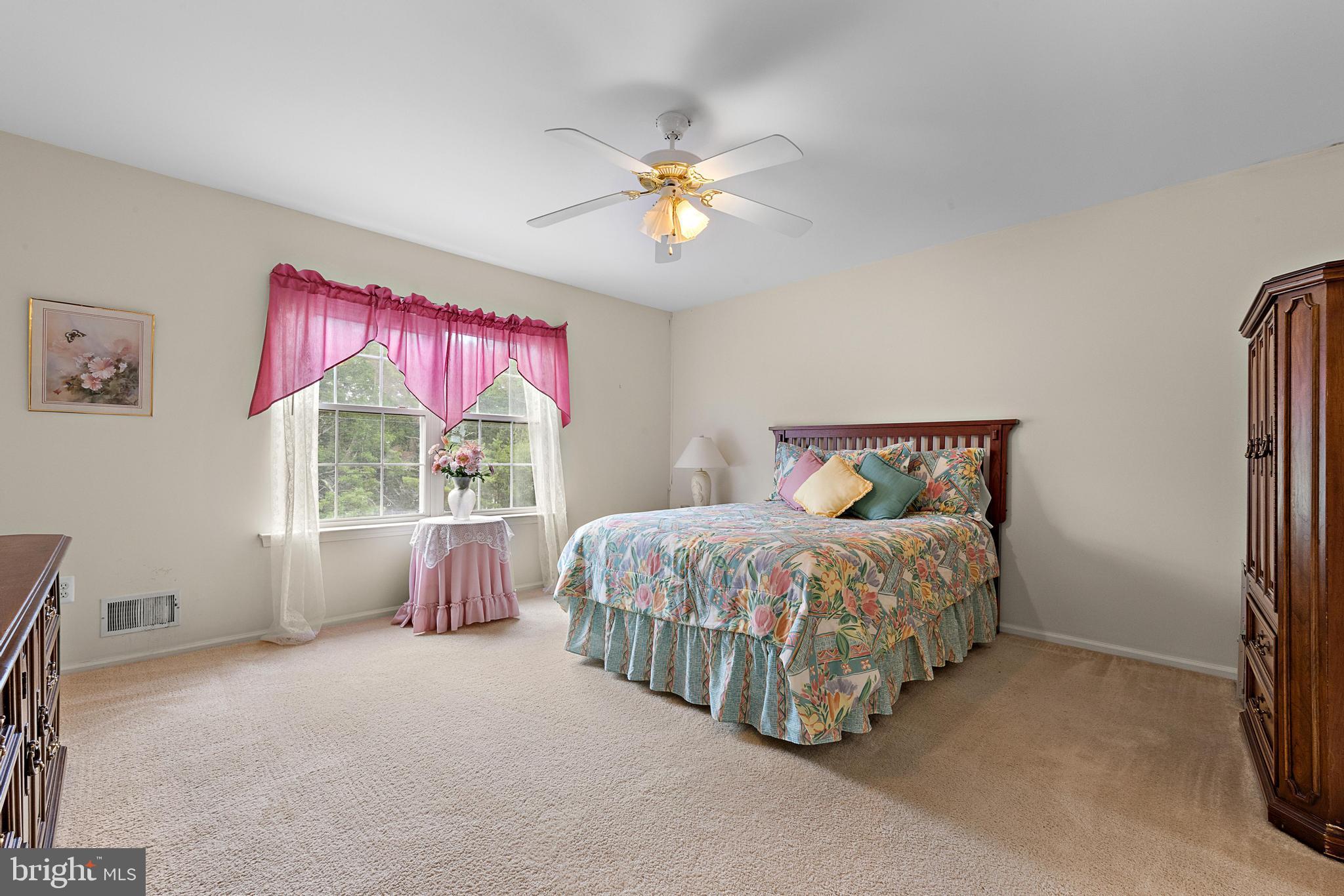 249 Topside Road Manahawkin, NJ 08050 - Photo 36 of 49 a bedroom with a bed and a chandelier