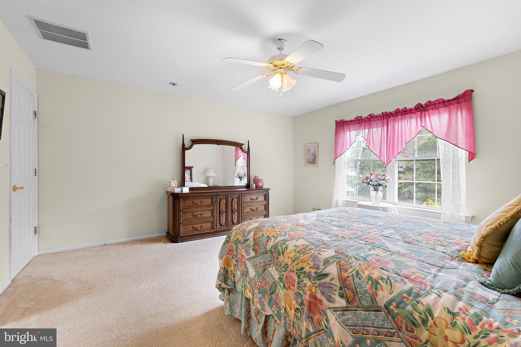 249 Topside Road Manahawkin, NJ 08050 - Photo 37 of 49 a bedroom with a bed and a chandelier
