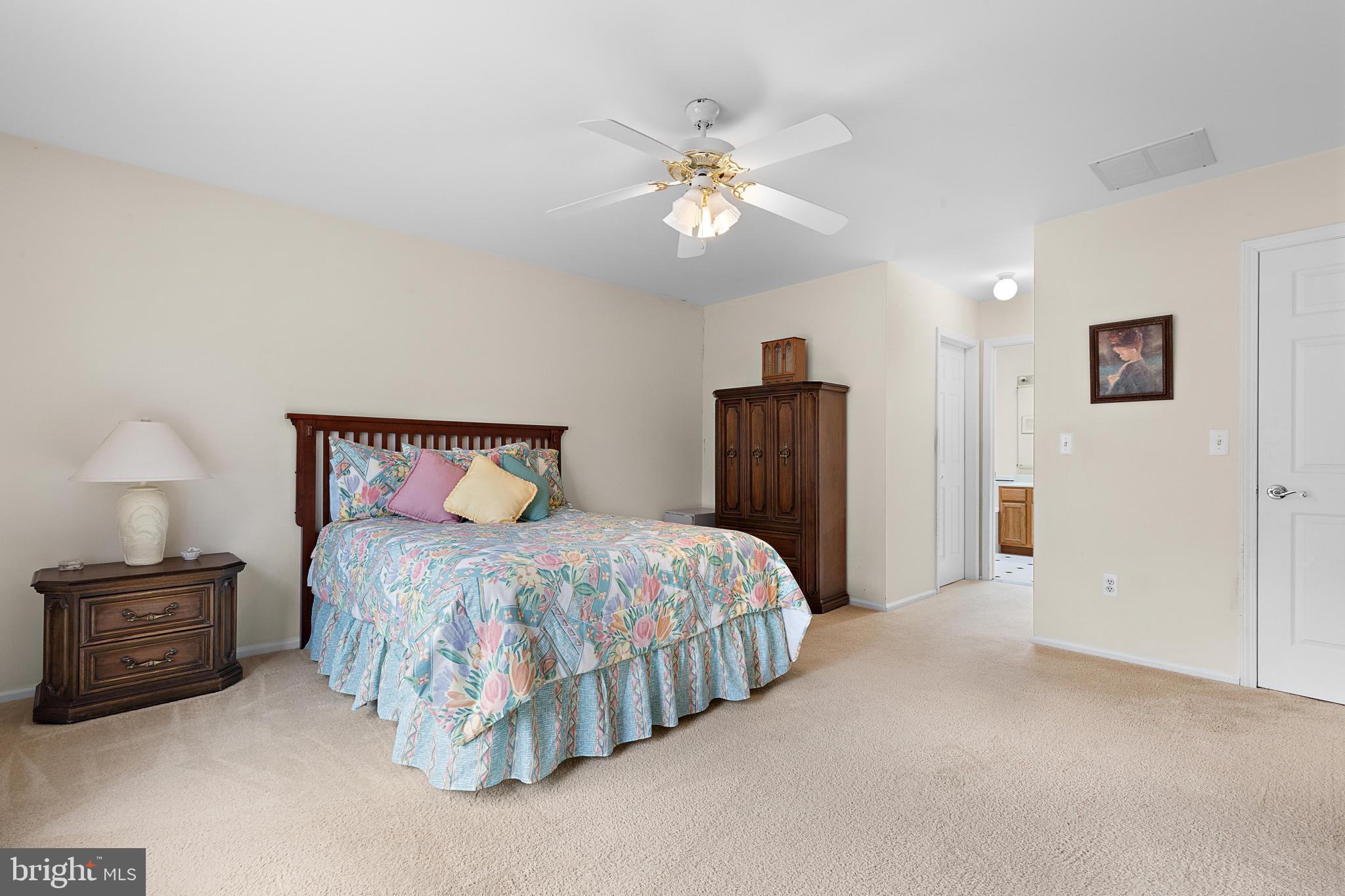 249 Topside Road Manahawkin, NJ 08050 - Photo 38 of 49 a bedroom with a bed and a lamp on the dresser