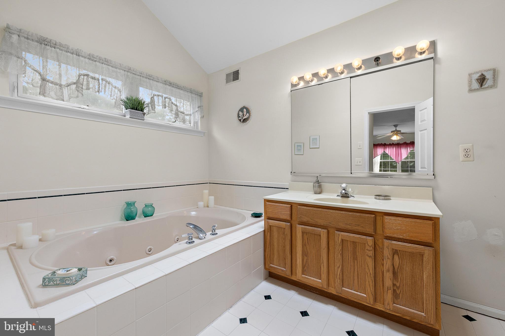 249 Topside Road Manahawkin, NJ 08050 - Photo 41 of 49 a bathroom with a tub sink and mirror