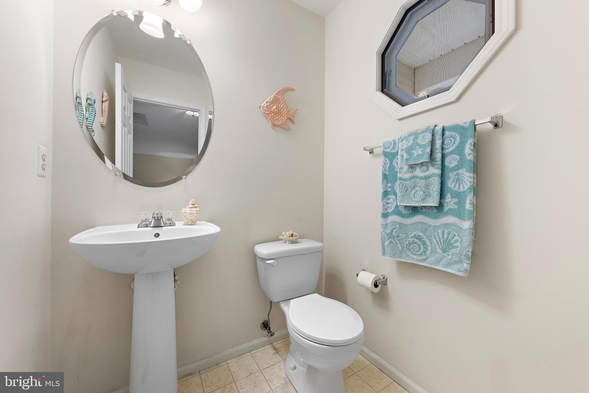 249 Topside Road Manahawkin, NJ 08050 - Photo 42 of 49 a bathroom with a toilet a sink and mirror