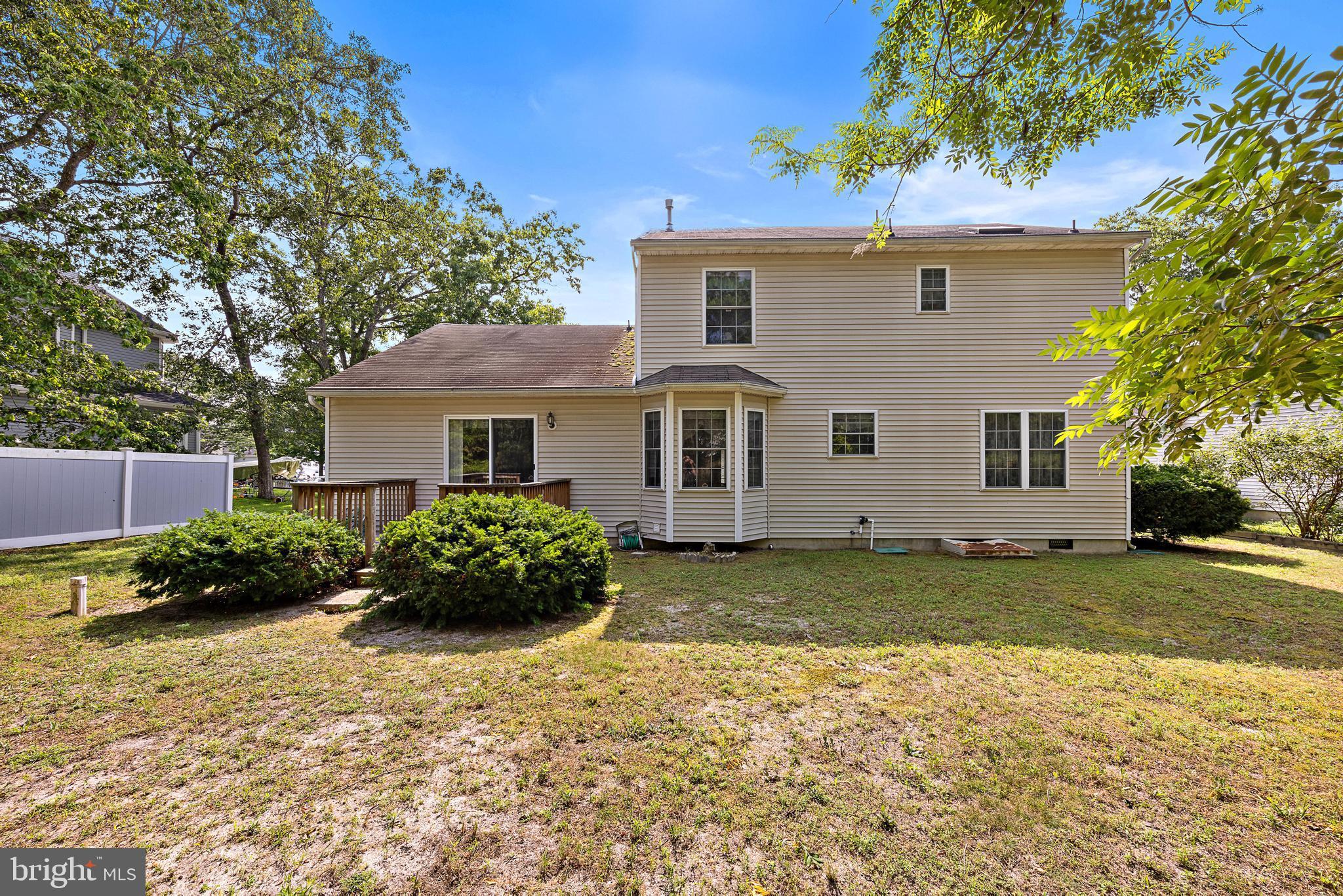 249 Topside Road Manahawkin, NJ 08050 - Photo 47 of 49 a front view of a house with a garden