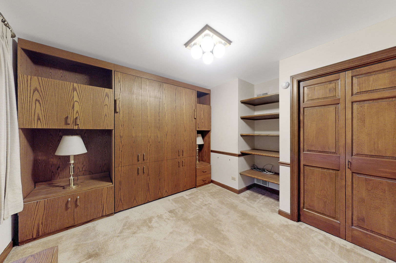 8282 Lake Ridge Drive Burr Ridge, IL 60527 - Photo 13 of 37 a view of a hallway with closet and cabinet