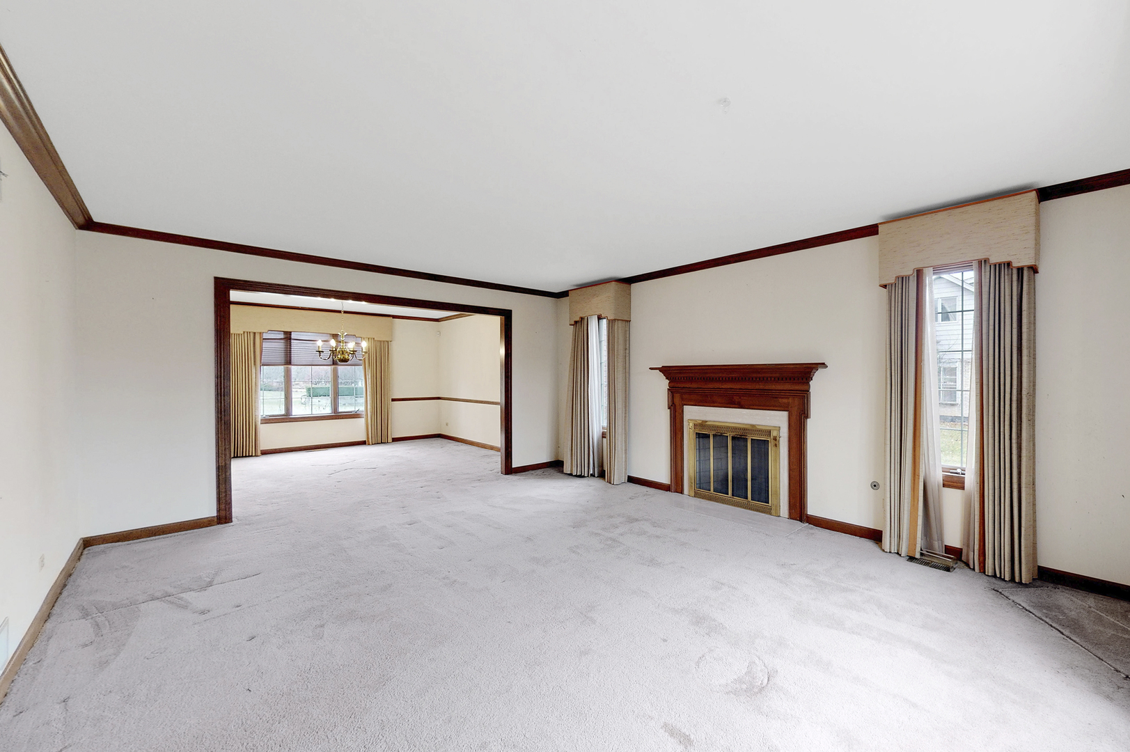 8282 Lake Ridge Drive Burr Ridge, IL 60527 - Photo 3 of 37 an empty room with fireplace and windows