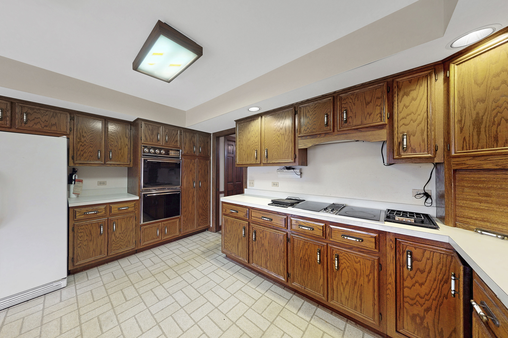 8282 Lake Ridge Drive Burr Ridge, IL 60527 - Photo 7 of 37 a kitchen with stainless steel appliances granite countertop a stove a sink and a refrigerator