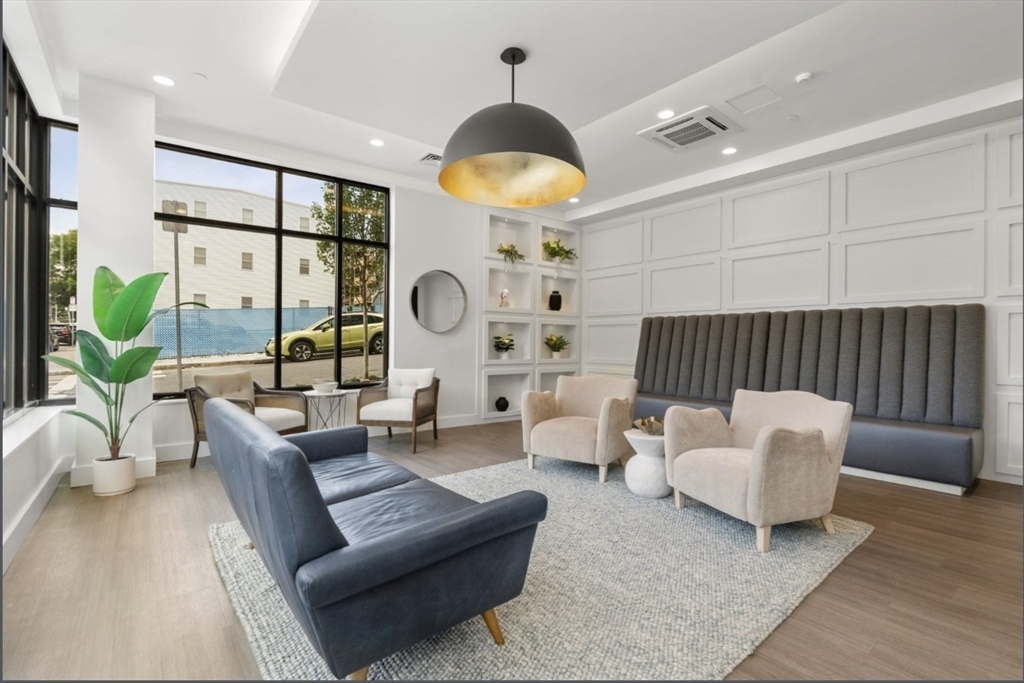 301 Border Street, Unit 610 Boston, MA 02128 - Photo 13 of 17 a living room with furniture and a large window