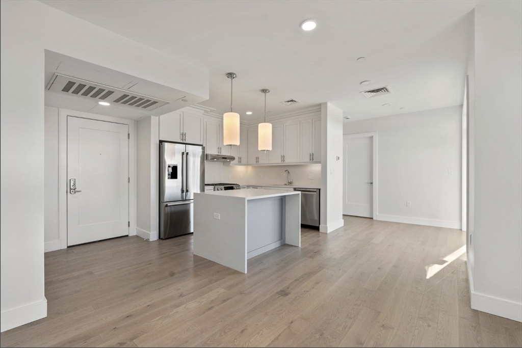 301 Border Street, Unit 610 Boston, MA 02128 - Photo 2 of 17 a kitchen with a refrigerator and white cabinets