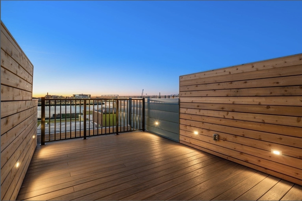 301 Border Street, Unit 610 Boston, MA 02128 - Photo 9 of 17 a view of balcony with floor to ceiling window and wooden floor