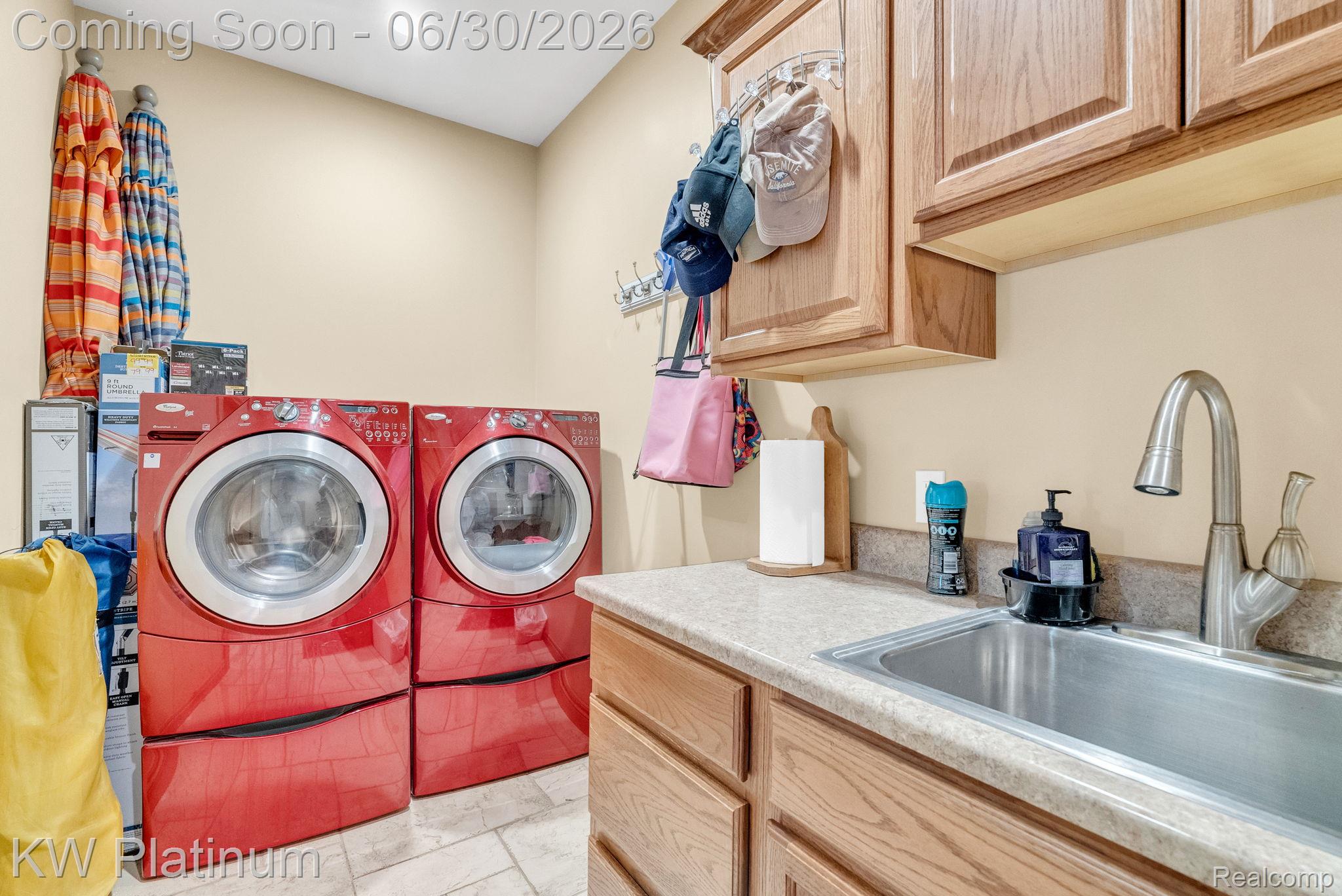 2235 South Lake Shore Road Harbor Beach, MI 48441 - Photo 25 of 99 Laundry area featuring a utility sink with a brushed nickel faucet, wood-finish cabinetry, and light-toned countertop