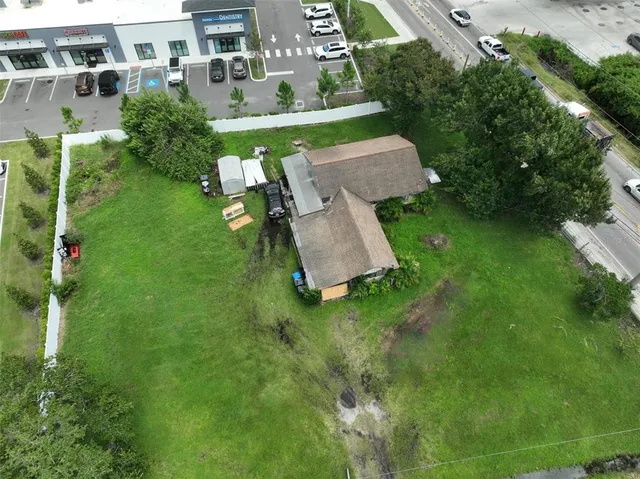 an aerial view of a house with a yard