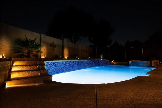 a view of a swimming pool with a yard