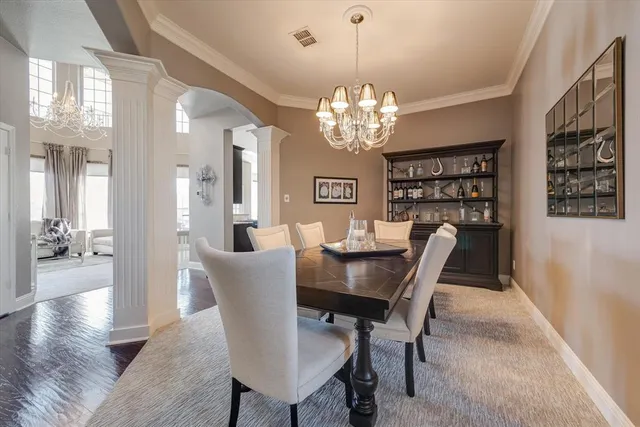 a view of a dining room with furniture wooden floor and chandelier