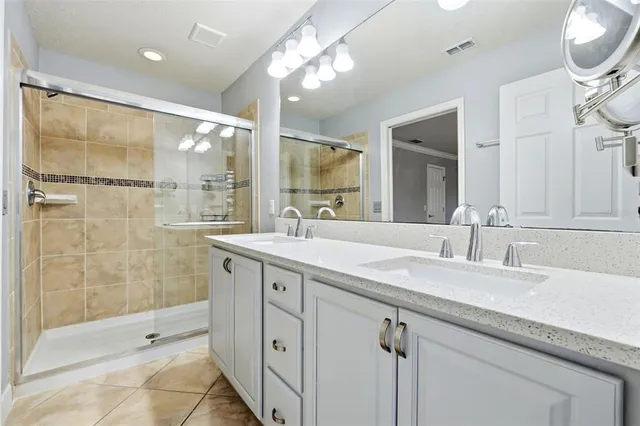 a bathroom with double vanity sink and a mirror