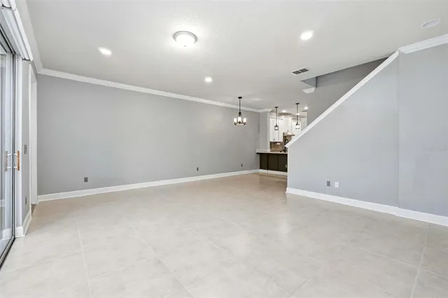 an empty room with an empty space and a ceiling fan