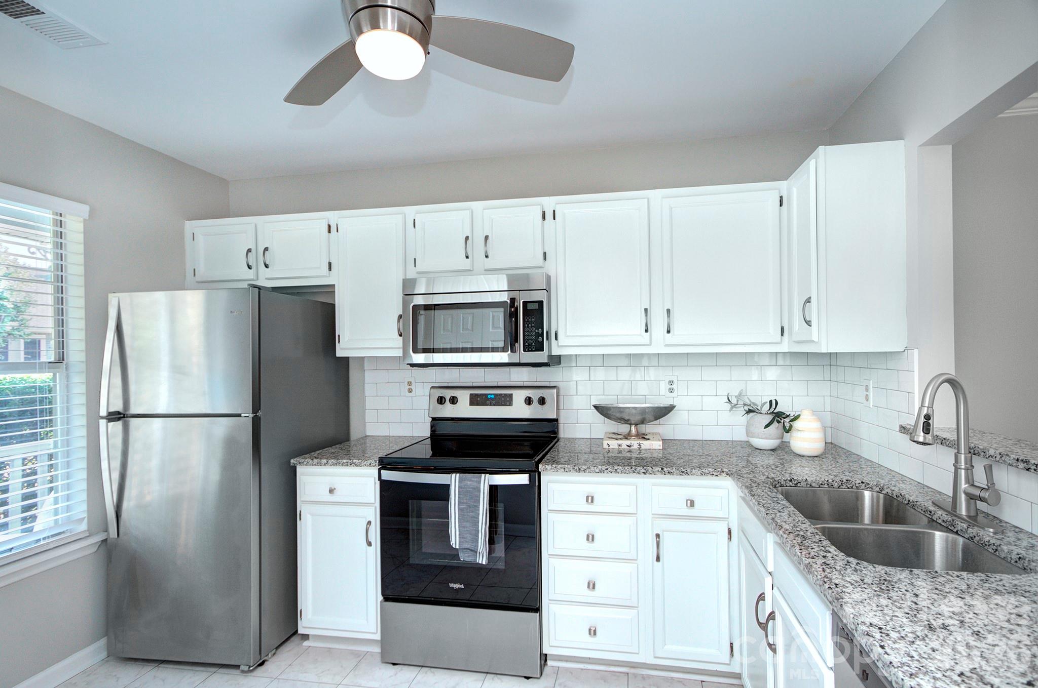8268 Golf Ridge Drive Charlotte, NC 28277 - Photo 6 of 24 a kitchen with refrigerator a stove a sink cabinets and a refrigerator