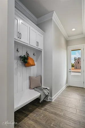 a living room with furniture and baby crib
