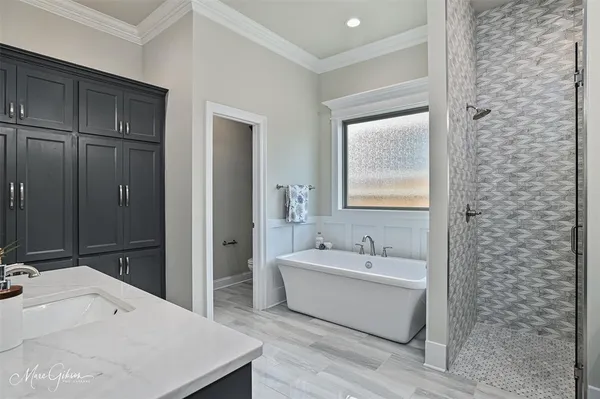 a spacious bathroom with a bathtub and shower