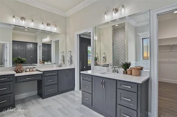 a bathroom with a sink double vanity and a mirror