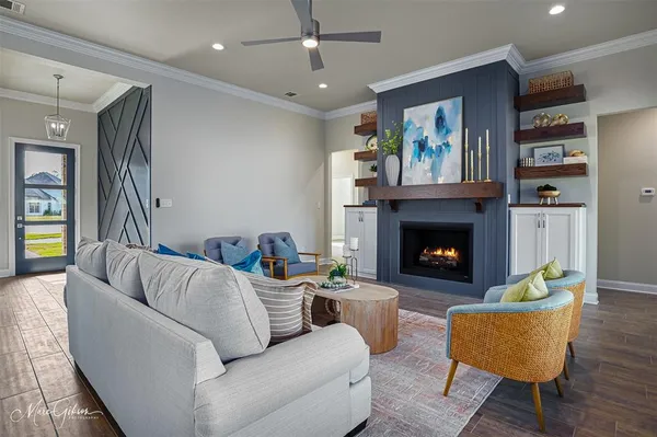 a living room with furniture and a fireplace