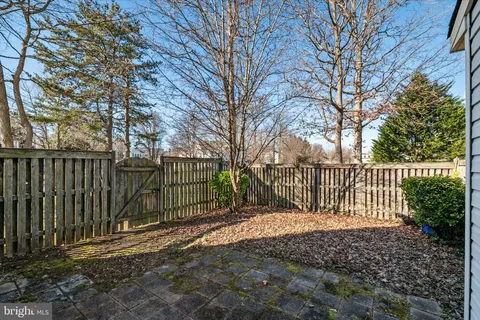 a view of a fence with a trees in the background