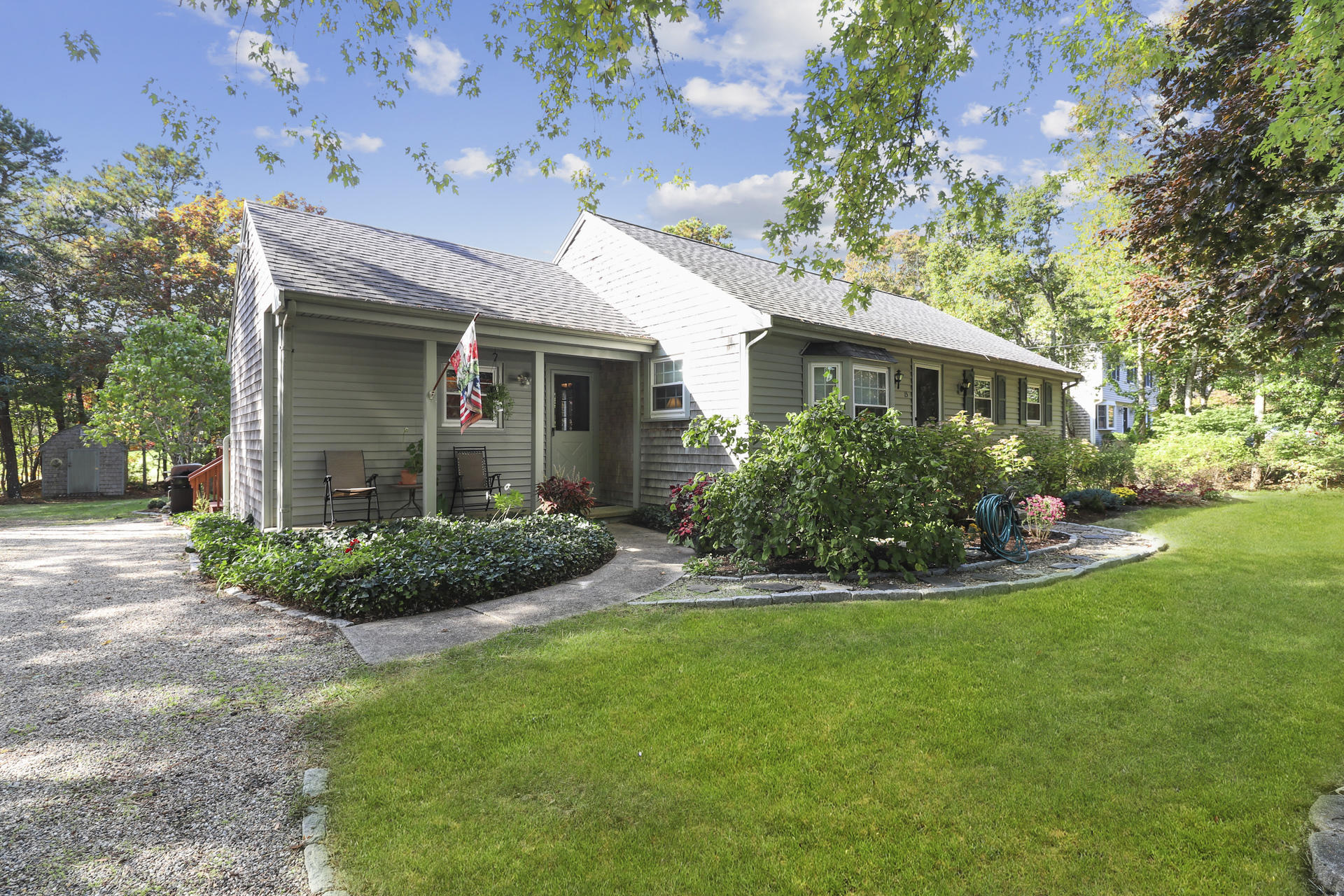 15 Ronda Lane Dennis, MA 02638 - Photo 2 of 20 a view of a house with brick walls and a yard with a large tree