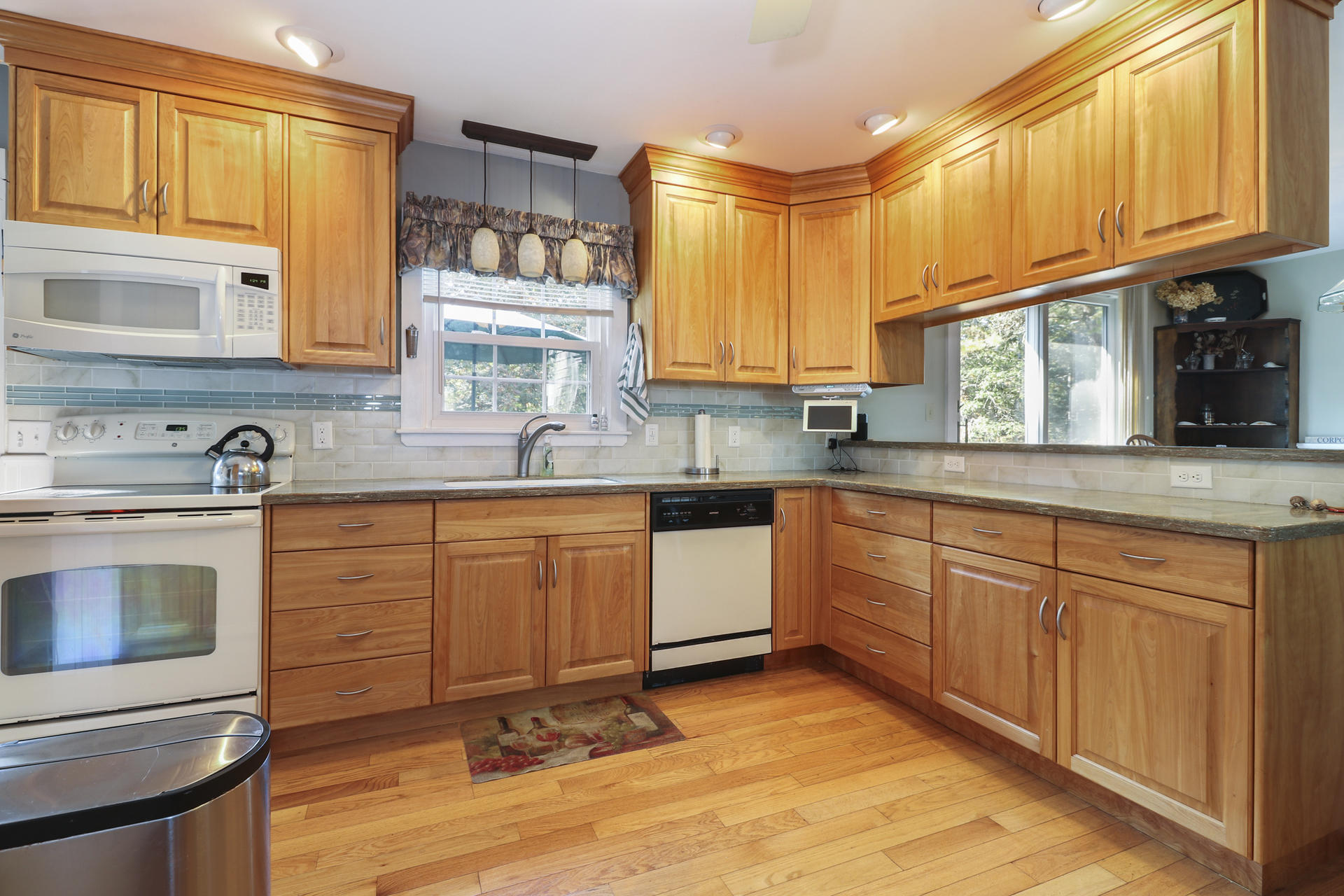 15 Ronda Lane Dennis, MA 02638 - Photo 5 of 20 a kitchen with stainless steel appliances granite countertop a sink a stove and cabinets