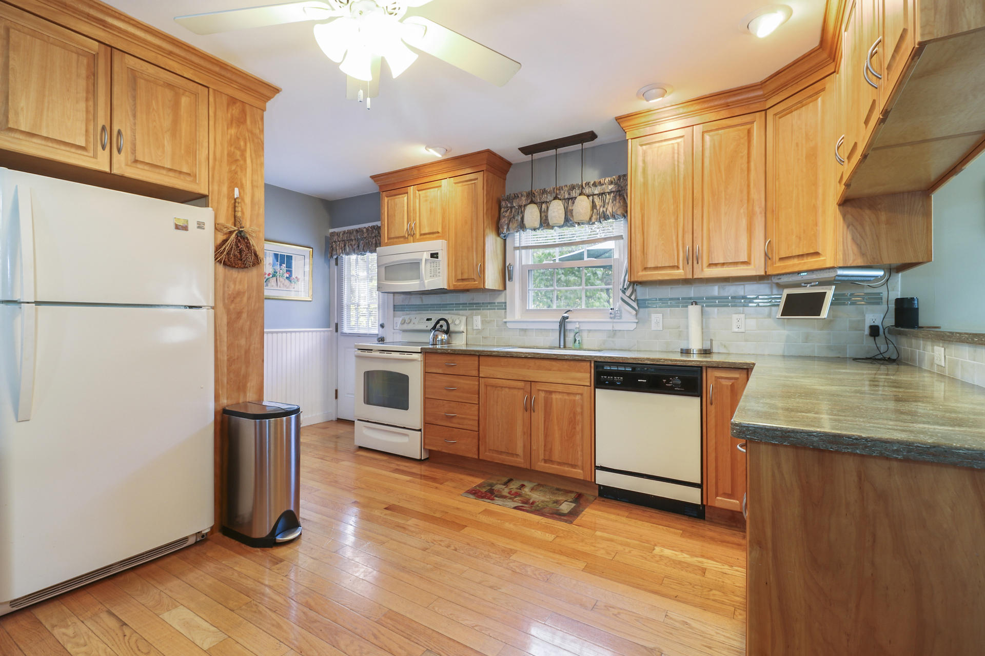 15 Ronda Lane Dennis, MA 02638 - Photo 6 of 20 a kitchen with stainless steel appliances granite countertop a refrigerator a sink dishwasher a stove with wooden floor
