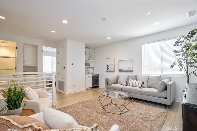 a view of staircase with white cabinets and a window